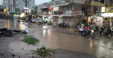 City drenched by drizzling rain, water filled in houses and shops, jam in the way of colonies